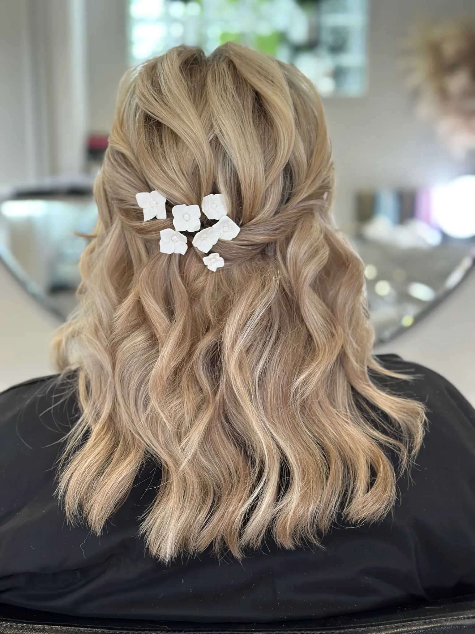 Bridal half-up hairstyle with Beauflora flower pins