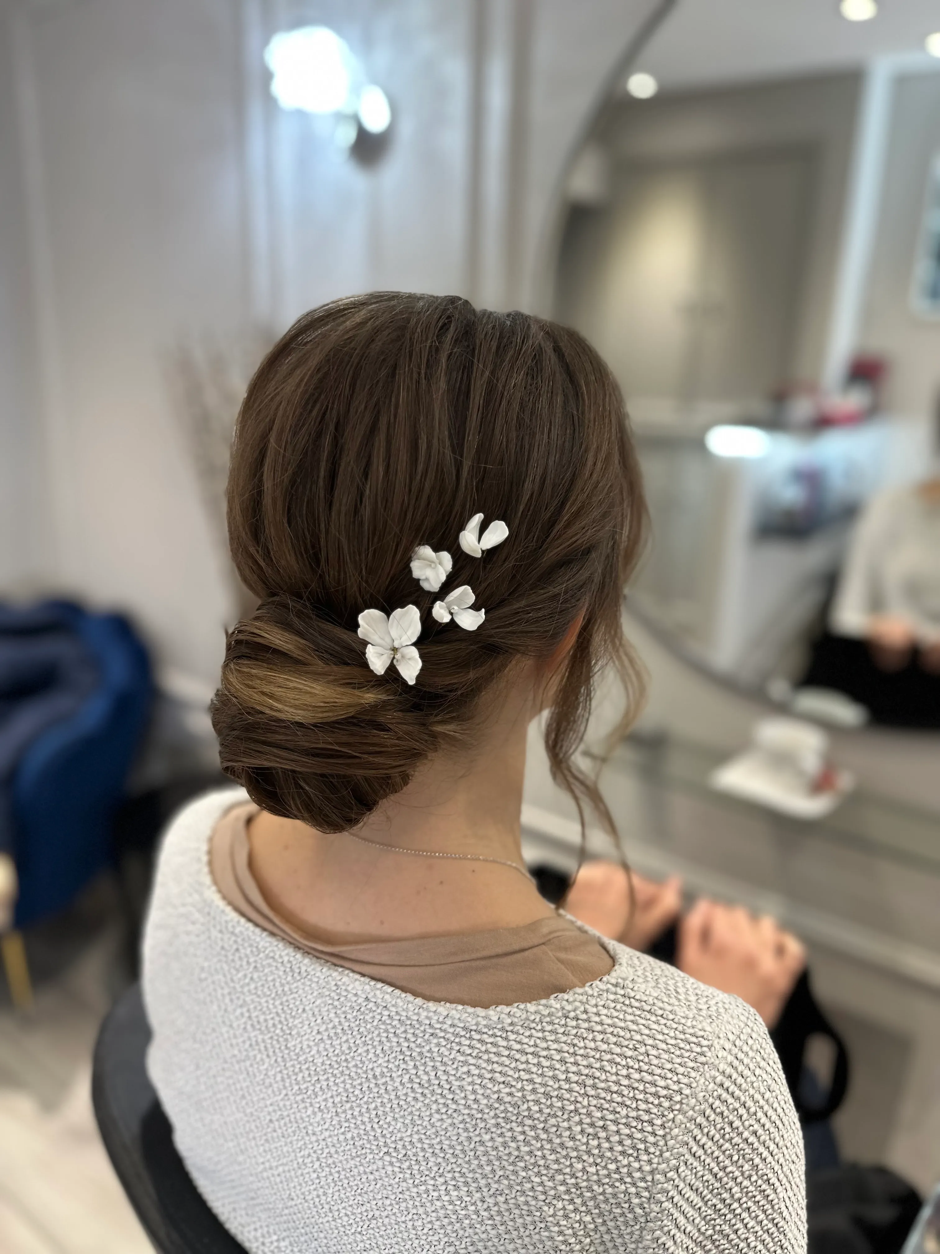 Delicate Beauflora flower pins in a polished low bun